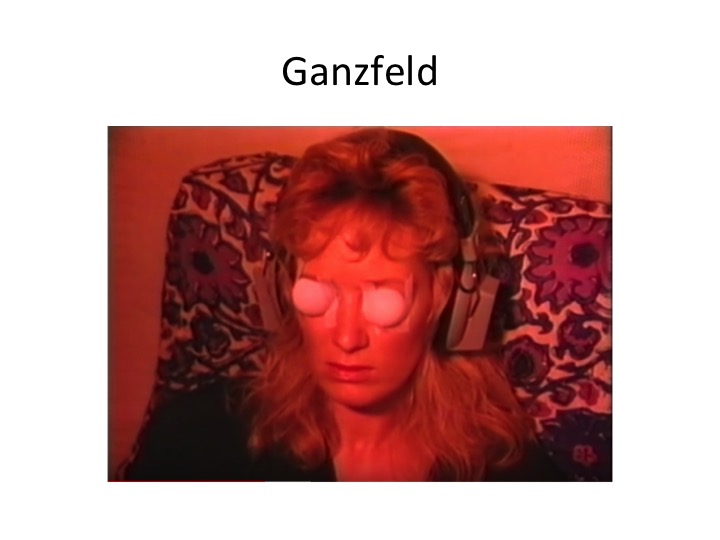 The Ganzfeld: a subject reclines under a red light, ping-pong-ball halves over the eyes, white noise in the ears.