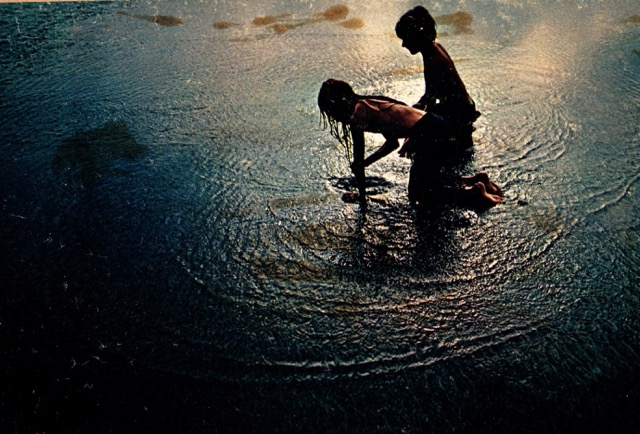 A target — boys playing in water at dusk.