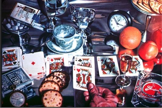The target — Audrey Flack’s photorealist painting “Solitaire” (1974) — whose title, date, and details the subject drew from.